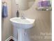 Bathroom featuring a white pedestal sink with modern fixtures at 3248 Park South Station Blvd, Charlotte, NC 28210