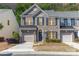 Charming brick townhome featuring a one car garage, blue shutters, and landscaped front yard at 3248 Park South Station Blvd, Charlotte, NC 28210