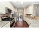 Kitchen with granite countertops, hardwood floors and stainless steel appliances at 3248 Park South Station Blvd, Charlotte, NC 28210