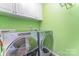 Laundry room features a washer and dryer and white cabinets at 3248 Park South Station Blvd, Charlotte, NC 28210