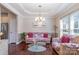 Bright living room with hardwood floors, a tray ceiling, and large windows at 3248 Park South Station Blvd, Charlotte, NC 28210