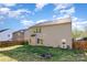 Backyard with a wooden fence and siding, showcasing the home's rear windows and door at 3882 Shasta Cir, Clover, SC 29710