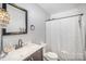 Bathroom features a framed mirror, vanity, toilet, and shower with printed curtain at 3882 Shasta Cir, Clover, SC 29710