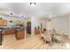 Open kitchen and dining area with wood floors, island, and ample cabinet space at 3882 Shasta Cir, Clover, SC 29710
