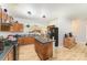 Well-lit kitchen features wood cabinets, an island, and a view into the living area at 3882 Shasta Cir, Clover, SC 29710