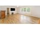 Open living room featuring wood floors, large windows, and plenty of natural light at 3882 Shasta Cir, Clover, SC 29710
