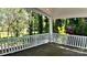 Inviting outdoor deck featuring a wood floor and views of lush trees at 420 Solomon St, Charlotte, NC 28216
