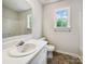 Clean bathroom with a white vanity, toilet, and bathtub with a shower and a window at 4222 Mt Gallant Rd, Rock Hill, SC 29732