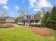 Charming home featuring a welcoming front porch, lush lawn, and beautiful landscaping at 4222 Mt Gallant Rd, Rock Hill, SC 29732