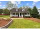 Charming home featuring a welcoming front porch, lush lawn, and beautiful landscaping at 4222 Mt Gallant Rd, Rock Hill, SC 29732