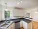 Bright kitchen featuring white cabinets, stainless steel appliances, and black countertops at 4222 Mt Gallant Rd, Rock Hill, SC 29732