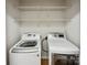 Convenient laundry area featuring a washer, dryer, and wire shelving for storage at 4222 Mt Gallant Rd, Rock Hill, SC 29732