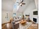 Bright living room boasts vaulted ceilings, fireplace, and neutral tones, perfect for relaxation and entertaining at 4222 Mt Gallant Rd, Rock Hill, SC 29732