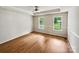 Spacious main bedroom with tray ceiling, hardwood floors, and natural light from two windows at 4222 Mt Gallant Rd, Rock Hill, SC 29732