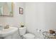 Bathroom with a pedestal sink, toilet, and a small side table at 562 Amalfi Dr, Davidson, NC 28036