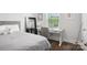 Bedroom with a bed, desk, gray chair, and bright windows at 562 Amalfi Dr, Davidson, NC 28036