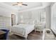 Serene bedroom features a white bed, matching nightstands, tray ceiling, and windows with blinds creating a calming atmosphere at 562 Amalfi Dr, Davidson, NC 28036
