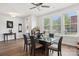Spacious dining area featuring a modern glass table, seating for six, and natural light streaming through the large windows at 562 Amalfi Dr, Davidson, NC 28036