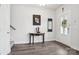 Inviting entryway features modern decor, wood-look floors, and a stylish table with decorative items, creating a warm welcome at 562 Amalfi Dr, Davidson, NC 28036