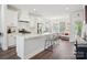 Bright, open kitchen features white cabinets, subway tile backsplash, stainless steel appliances, and a view to the living room at 562 Amalfi Dr, Davidson, NC 28036