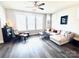 Bright living room with hardwood floors, sectional sofa, ceiling fan, and large window at 562 Amalfi Dr, Davidson, NC 28036