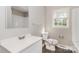 Bathroom featuring a new vanity with mirror, toilet and shower/tub combination, plus a window providing natural light at 6001 Plaza Ln, Charlotte, NC 28215