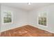 Bright bedroom featuring hardwood floors and ample natural light at 6001 Plaza Ln, Charlotte, NC 28215