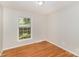 Simple bedroom featuring hardwood floors and natural light at 6001 Plaza Ln, Charlotte, NC 28215