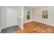 Bright entryway featuring hardwood floors, fresh paint, and a staircase at 6001 Plaza Ln, Charlotte, NC 28215