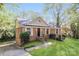 Charming home with a manicured lawn, brick facade, and inviting front entrance surrounded by lush greenery at 6001 Plaza Ln, Charlotte, NC 28215