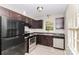 Functional kitchen with modern appliances and dark cabinetry at 6001 Plaza Ln, Charlotte, NC 28215