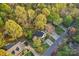 An aerial view shows a home nestled amongst trees in a well-maintained neighborhood at 6005 Lanai Ln, Tega Cay, SC 29708