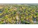 Aerial view of a home surrounded by lush trees, located near a lake and golf course at 6005 Lanai Ln, Tega Cay, SC 29708