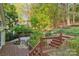 A multi-tiered backyard features a wood deck and staircase leading to a lush green space at 6005 Lanai Ln, Tega Cay, SC 29708