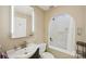 Bright bathroom featuring an arched shower and tub combo, mirrored cabinet, and neutral color palette at 6005 Lanai Ln, Tega Cay, SC 29708