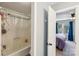 A bathroom adjacent to a bedroom featuring a combined tub and shower at 6005 Lanai Ln, Tega Cay, SC 29708