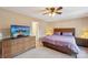 Spacious bedroom with a large TV, wooden dresser, and a comfortable bed at 6005 Lanai Ln, Tega Cay, SC 29708