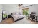 Bedroom with a full-sized bed, a ceiling fan, and a large window with a wooded view at 6005 Lanai Ln, Tega Cay, SC 29708