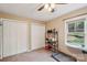 Neutral bedroom features carpet flooring, ceiling fan, two closets, and a shelf for organized storage solutions at 6005 Lanai Ln, Tega Cay, SC 29708