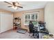 Office/bedroom with a large window view, pet bed, closet and ceiling fan at 6005 Lanai Ln, Tega Cay, SC 29708
