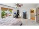 Bedroom with a full-sized bed, a ceiling fan, and a window with a wooded view at 6005 Lanai Ln, Tega Cay, SC 29708