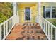 Close-up of house number and brick steps to the front door with white railing at 6005 Lanai Ln, Tega Cay, SC 29708
