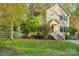 Yellow two-story house with a well-manicured lawn and inviting entrance steps at 6005 Lanai Ln, Tega Cay, SC 29708