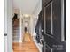 Inviting foyer with hardwood floors, staircase, and open view to the dining room at 6005 Lanai Ln, Tega Cay, SC 29708