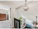 Upstairs hallway with fireplace, views and modern chandelier at 6005 Lanai Ln, Tega Cay, SC 29708