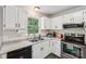 Bright and airy kitchen with stainless steel appliances, light countertops, and natural lighting at 6005 Lanai Ln, Tega Cay, SC 29708