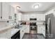 Bright and airy kitchen with stainless steel appliances and stone countertops at 6005 Lanai Ln, Tega Cay, SC 29708