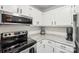 Close-up of a kitchen with modern stainless steel appliances, light countertops, and natural lighting at 6005 Lanai Ln, Tega Cay, SC 29708