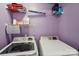 Laundry room featuring a side-by-side washer and dryer, shelving, and calming purple walls at 6005 Lanai Ln, Tega Cay, SC 29708