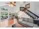 Bright living room with hardwood floors, stairs, and sliding glass doors leading to the outdoor patio at 6005 Lanai Ln, Tega Cay, SC 29708